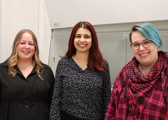 A photo of Melissa, Masa, and Christina in the Alphalyse lab